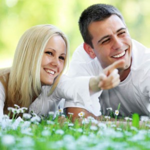 Blond girl resting with her boyfriend , showing with finger.