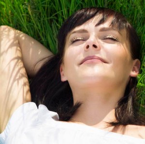 beautiful girl lying down of grass. Copy space
