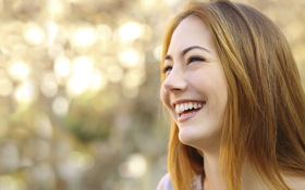 woman smiling with porcelain dental veneers from dentist in Elgin, IL