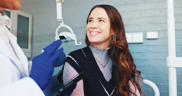 young woman smiling in a modern dental office