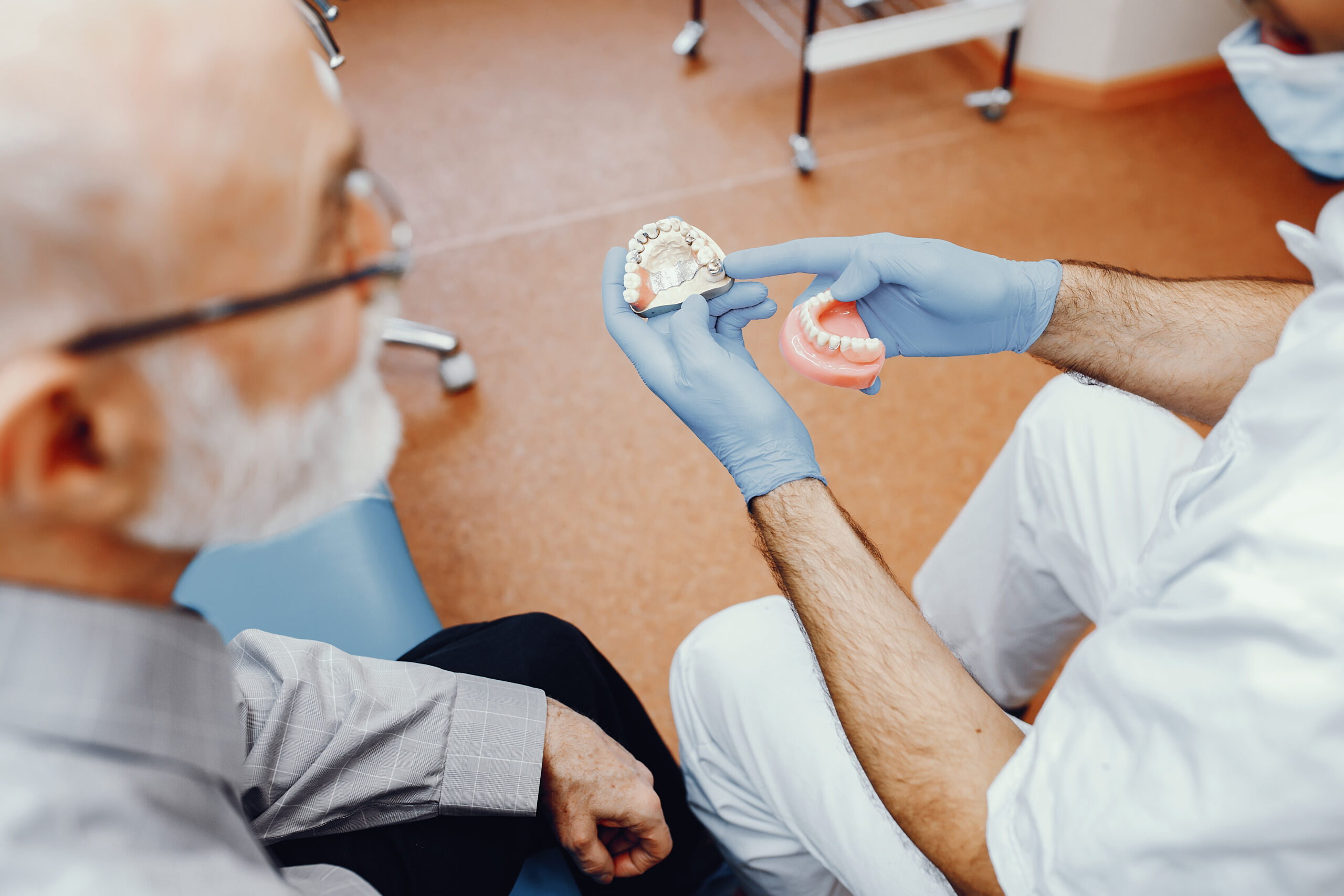 doctor showing a tooth replacement option to a patient