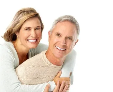 Older couple smiling with dental implants in Elgin.