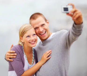 A young couple smiling after using FSA funds for porcelain veneers in Elgin.